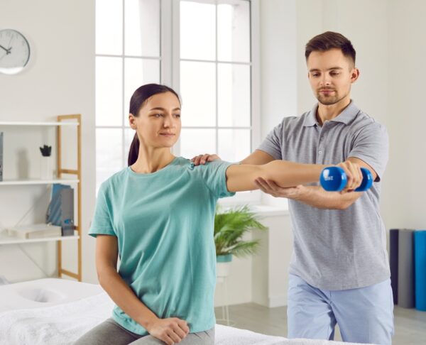 Young,Happy,Smiling,Woman,Patient,Doing,Sport,Exercise,Using,Dumbbells
